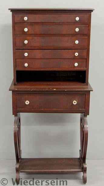 Appraisal: Victorian mahogany veneered cabinet with five shallow drawers above a