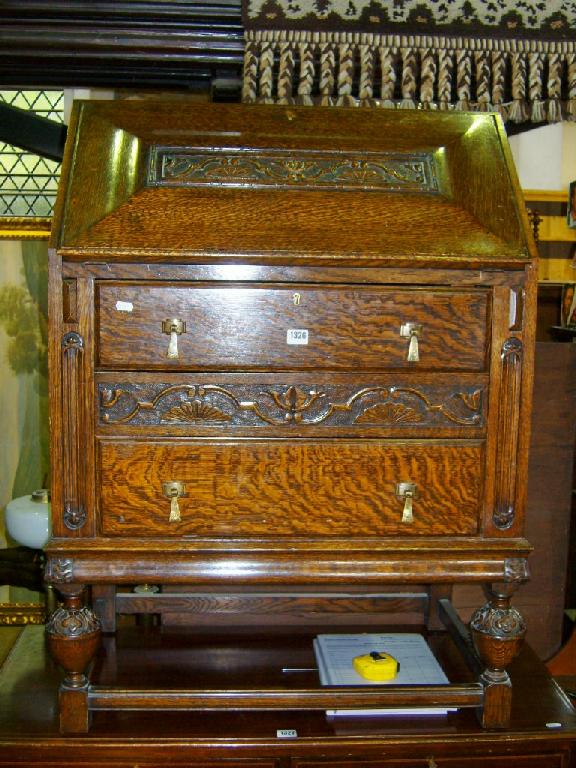 Appraisal: A good quality 's oak bureau the shaped and carved