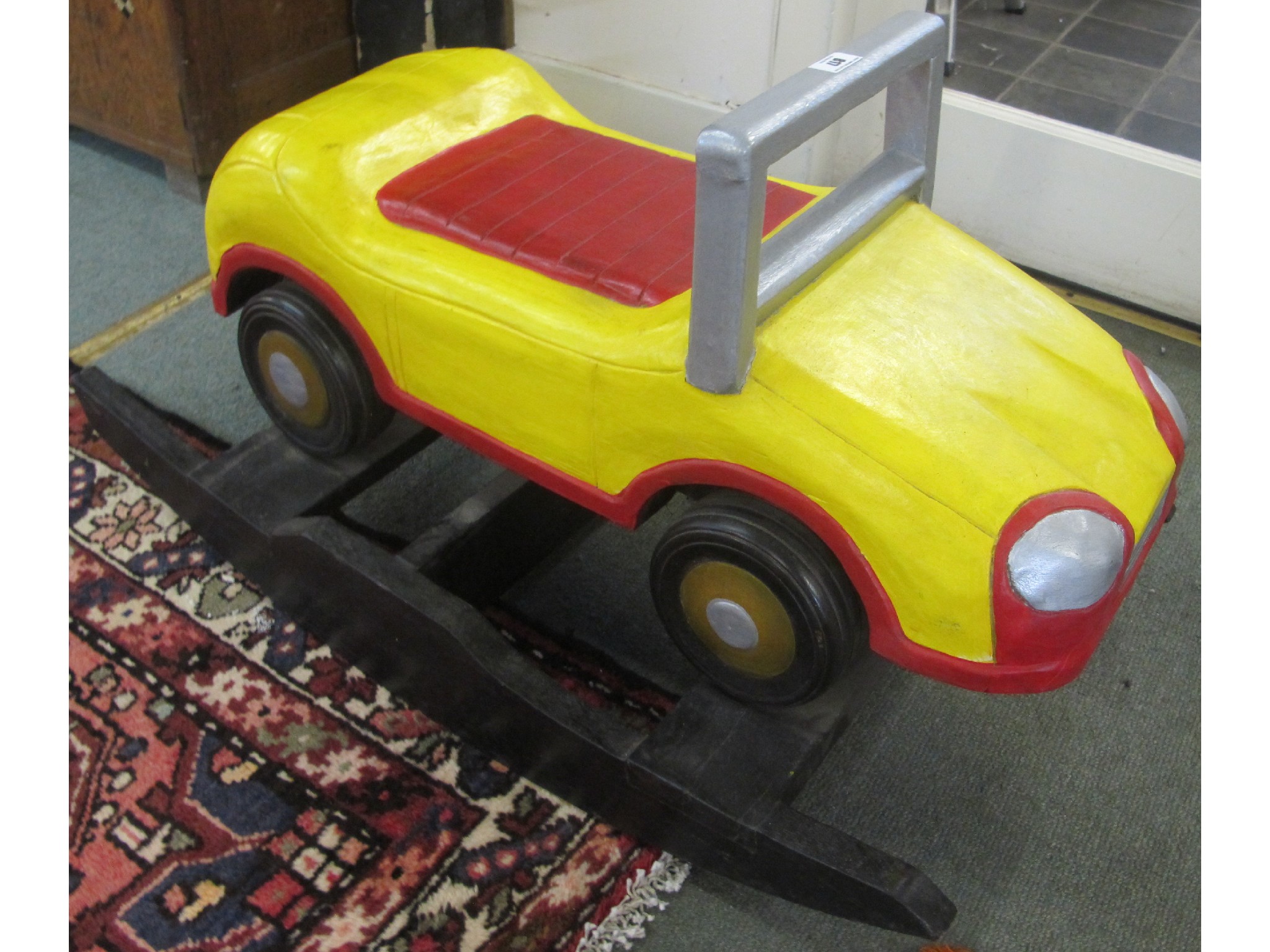 Appraisal: A yellow wooden rocker car