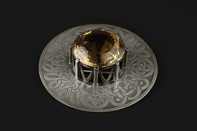 Appraisal: A SCOTTISH CITRINE PLAID BROOCH the circular white metal panel