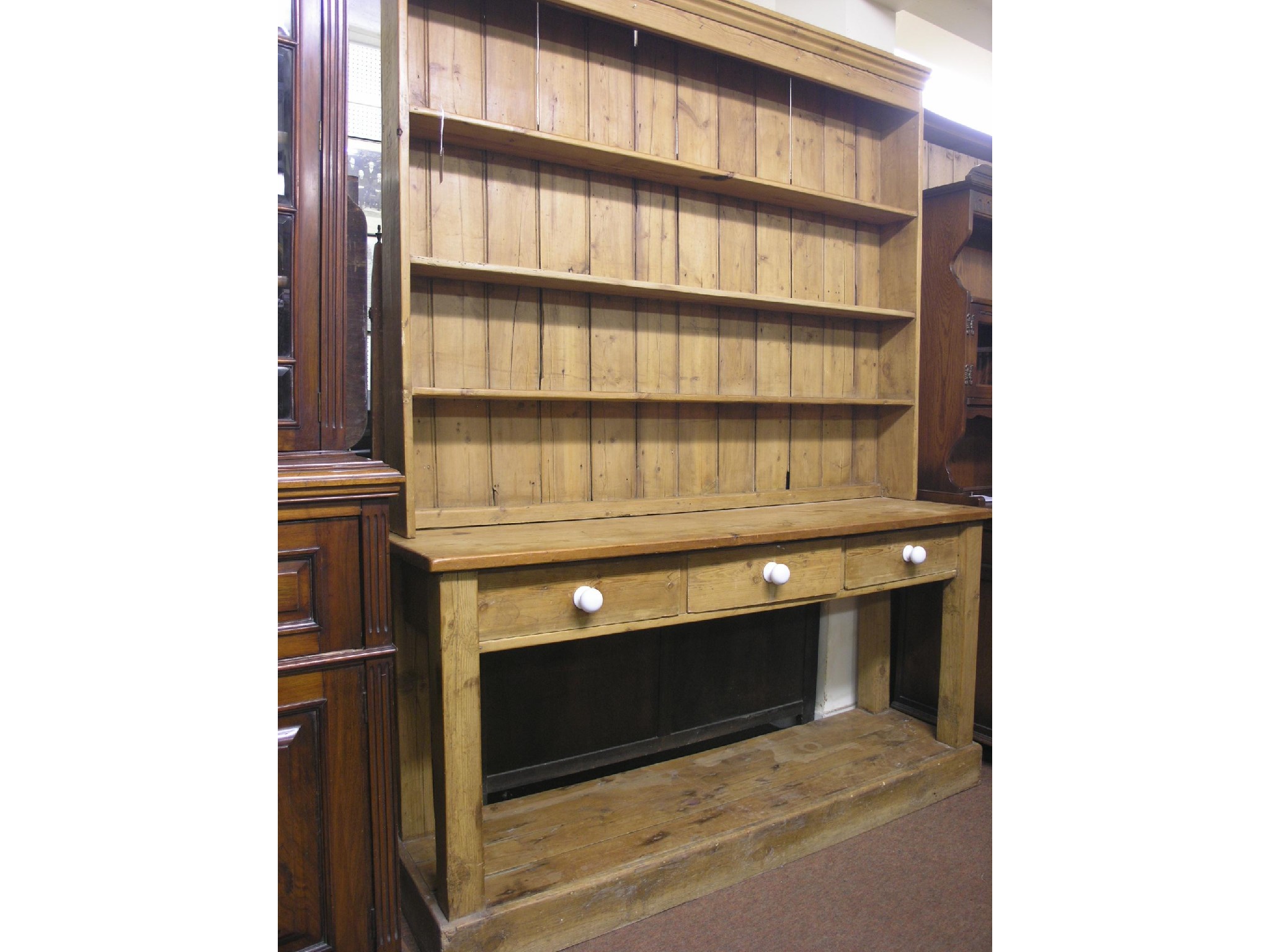 Appraisal: A Victorian pine kitchen dresser three-shelf plate rack above three