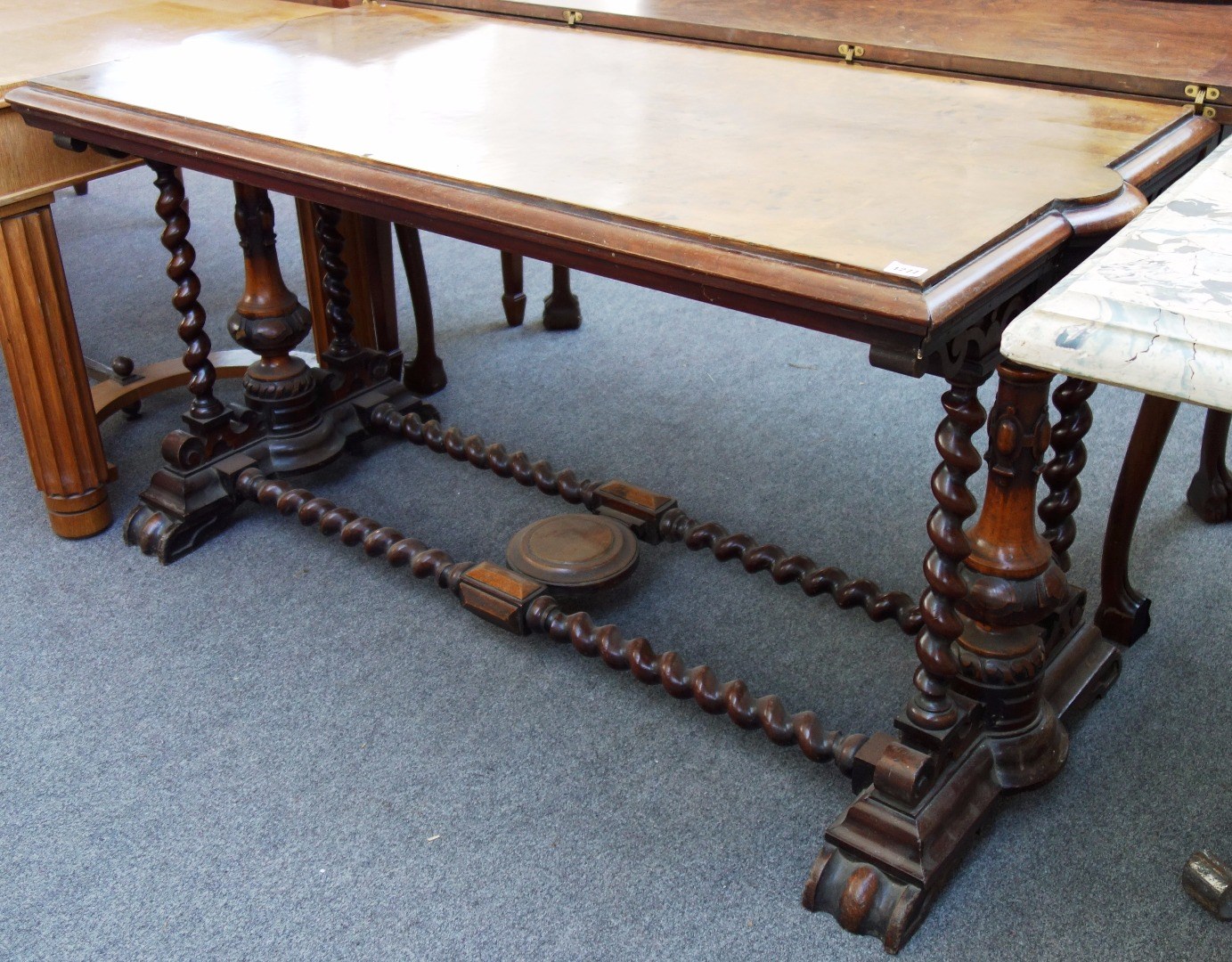 Appraisal: A Victorian figured walnut rectangular centre table on turned column