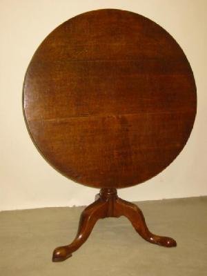 Appraisal: A GEORGE III OAK TRIPOD TABLE the circular tip up