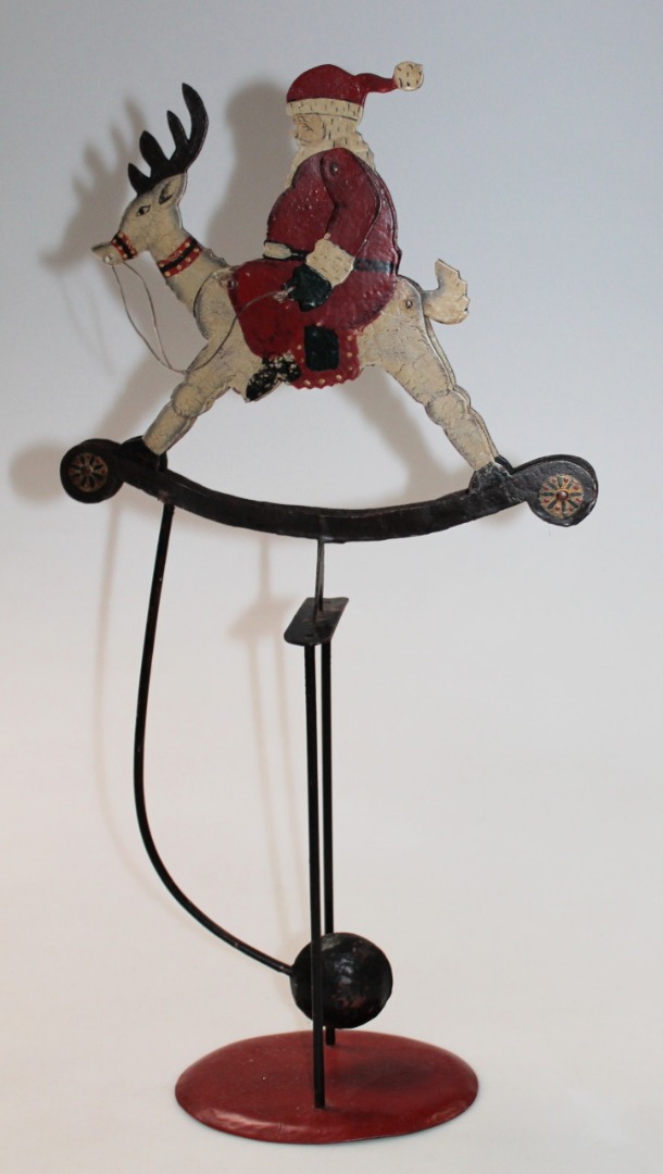 Appraisal: A thC articulated Father Christmas toy pendulum swung with moving