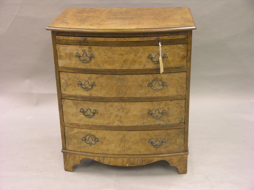 Appraisal: A burr walnut veneered chest with brushing slide above four