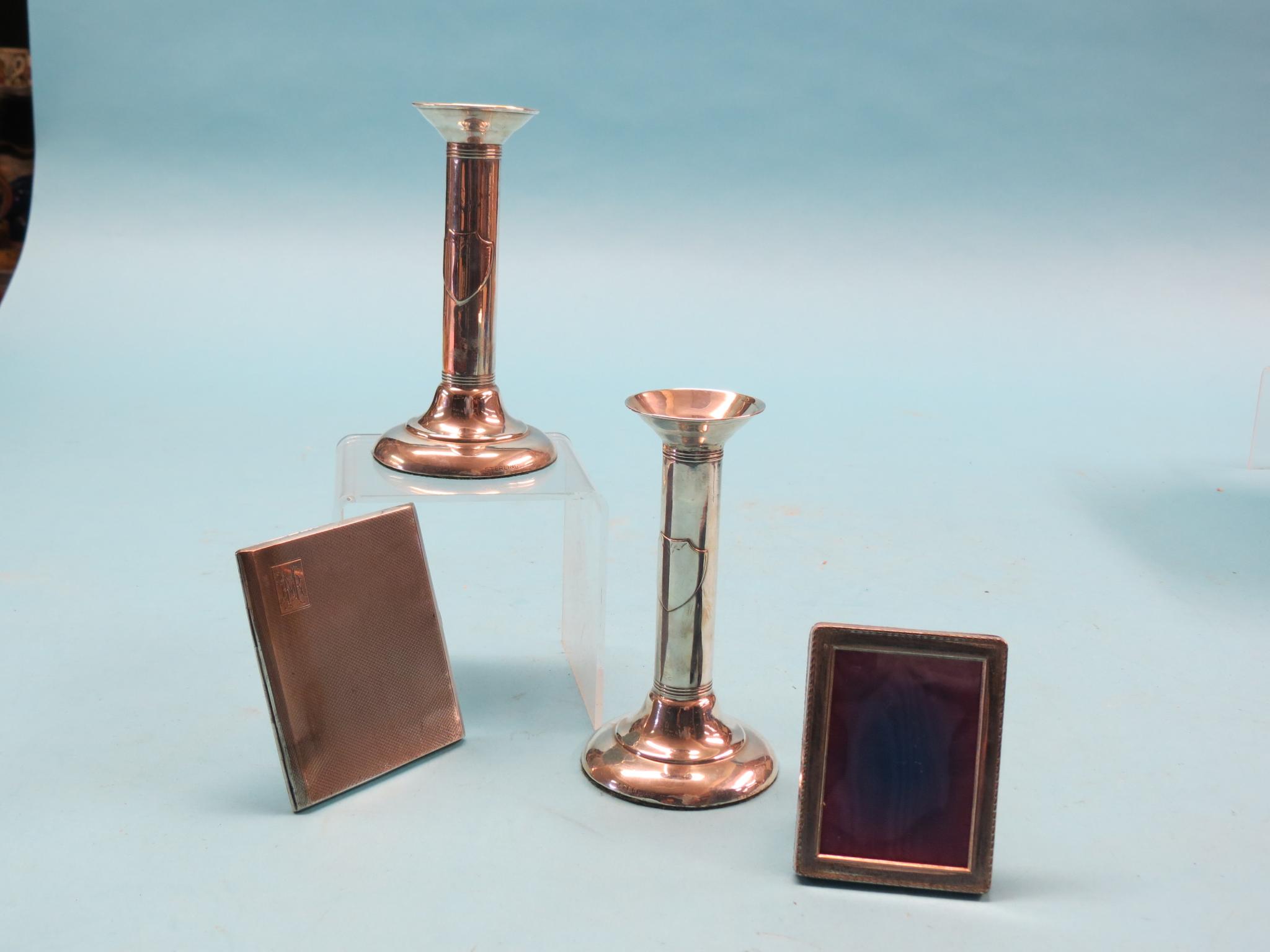 Appraisal: A pair of Sterling candlesticks with tubular stems in together