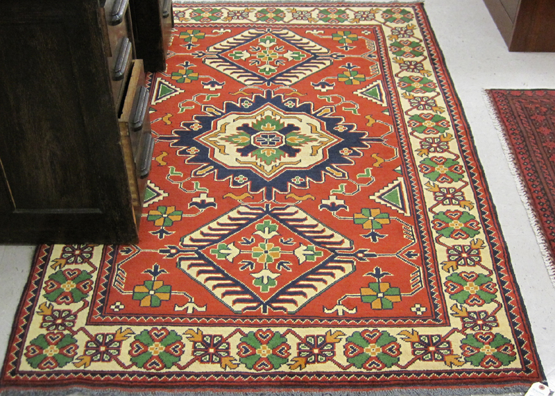 Appraisal: HAND KNOTTED ORIENTAL AREA RUG Pakistani-Caucasian three geometric medallion and