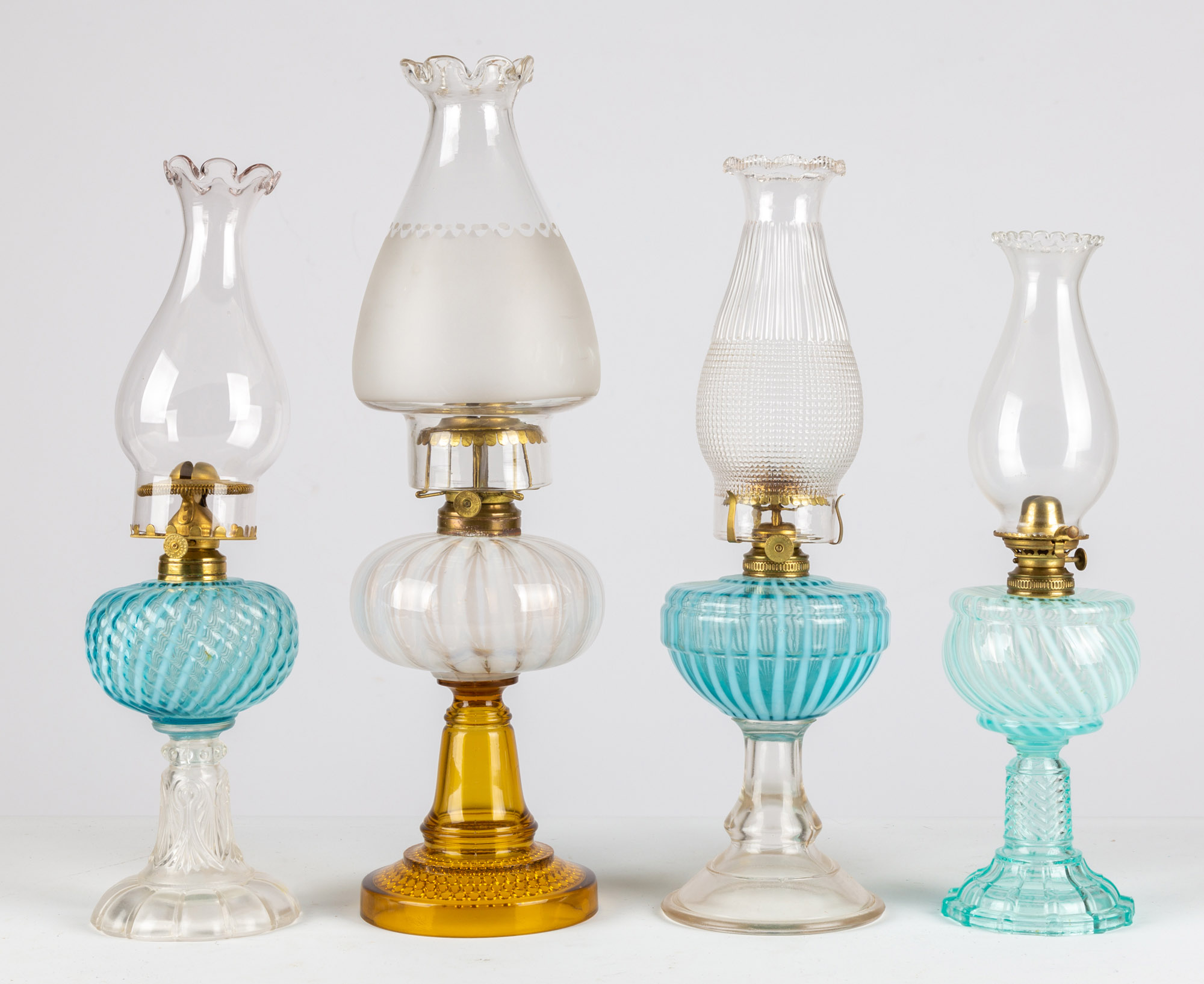 Appraisal: OPALESCENT SWIRL STRIPED OIL LAMPS circa period burners and shades