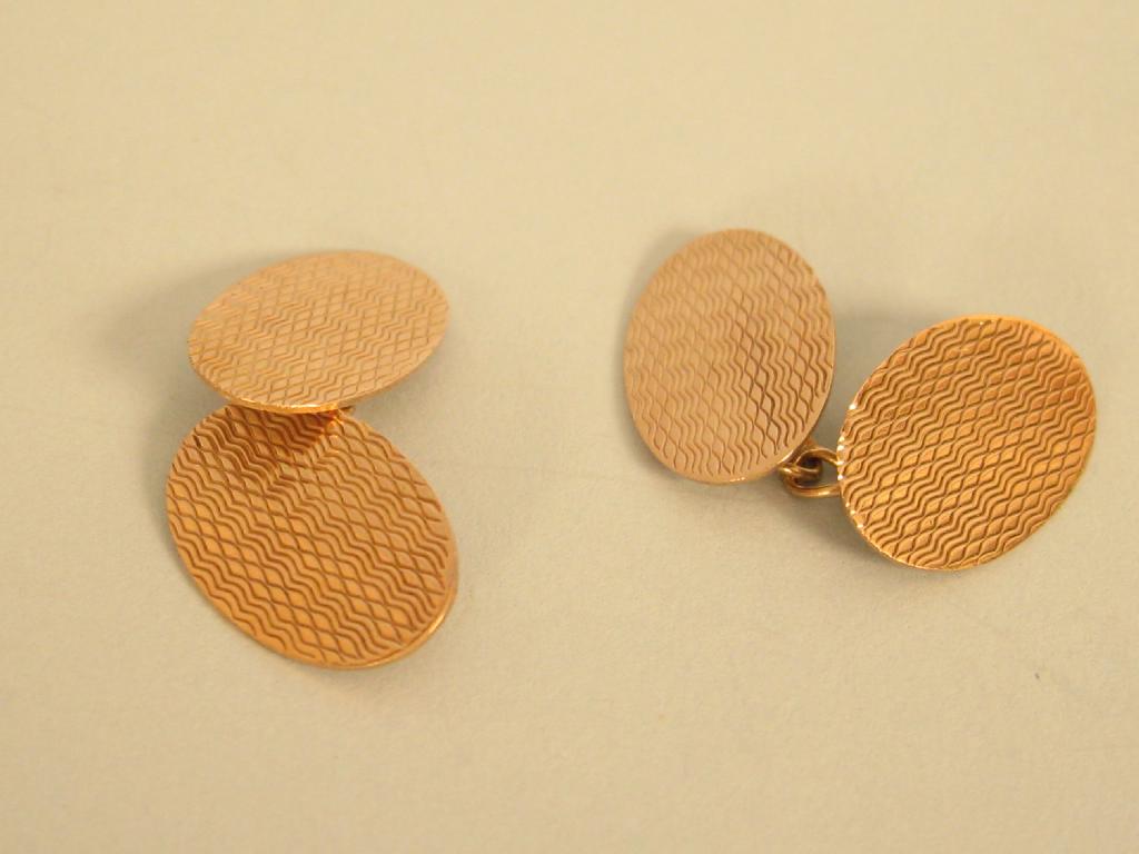 Appraisal: A pair of ct gold Cufflinks oval shaped with engine