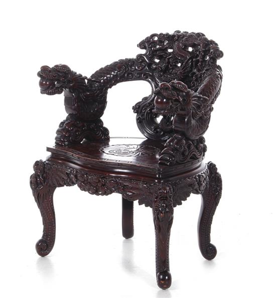 Appraisal: Chinese carved hardwood armchair early th century dragon-carved handrest cabriole