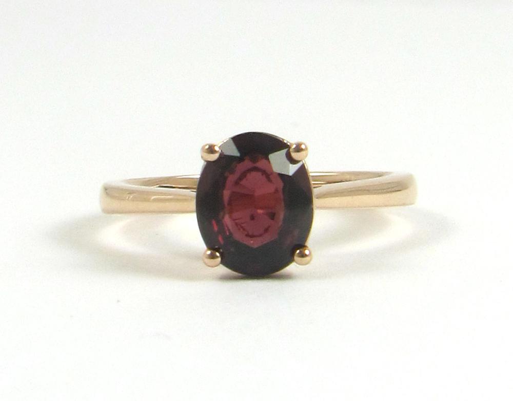 Appraisal: GARNET AND FOURTEEN KARAT ROSE GOLD RING with four rose