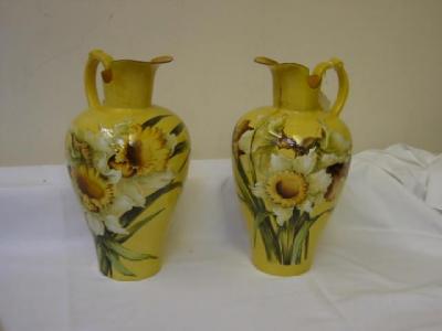 Appraisal: A PAIR OF DOULTON LAMBETH CO FAIENCE EWERS painted in