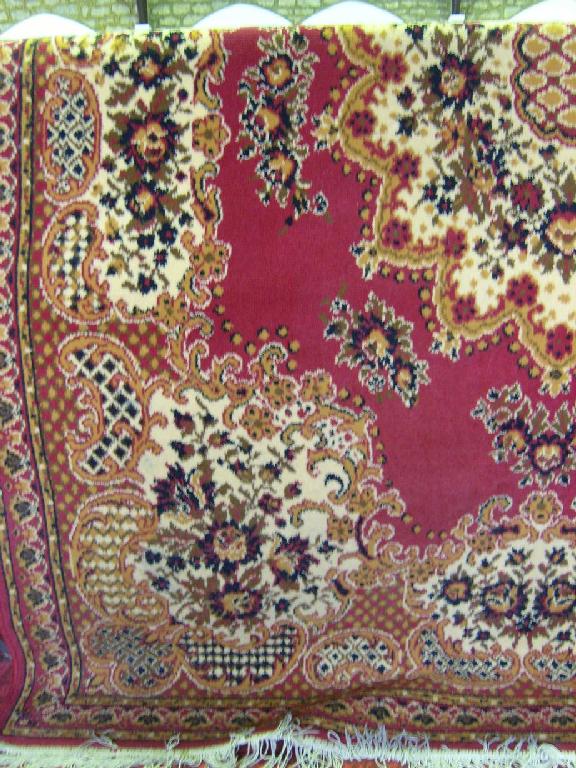 Appraisal: A wool rug in a Persian style with red ground