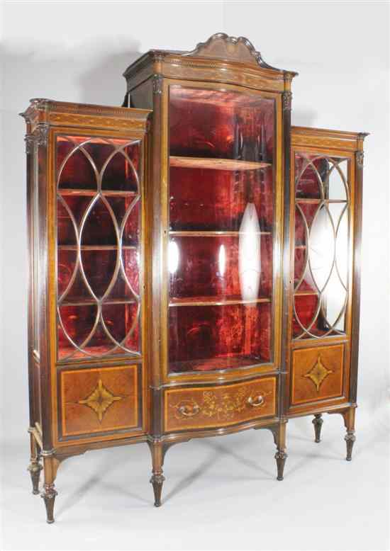 Appraisal: Maple Co A large Edwardian inlaid mahogany serpentine display cabinet