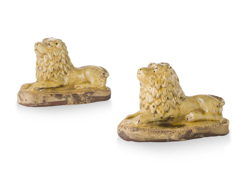 Appraisal: PAIR OF YELLOW GLAZED REDWARE FIGURES OF LIONS TH CENTURY