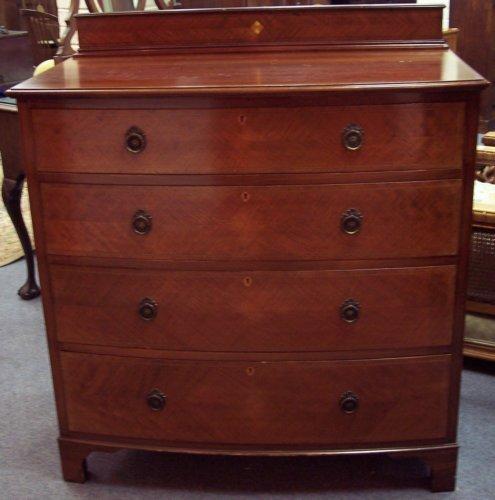 Appraisal: An Edwardian satinwood bowfront chest fitted four graduated drawers on