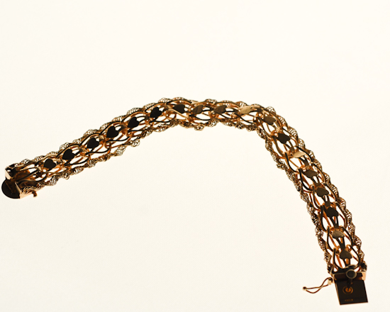 Appraisal: A Gold Bracelet having flexible heart links bordered by rope