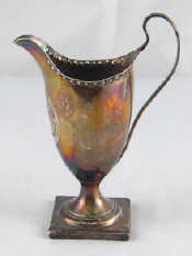 Appraisal: A Georgian silver helmet cream jug with punched rim on