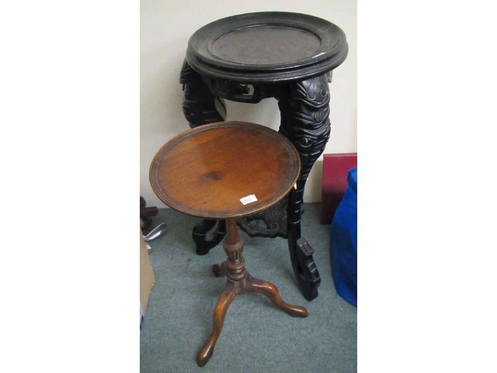 Appraisal: Eastern ebonised elephant plant stand and a wine table