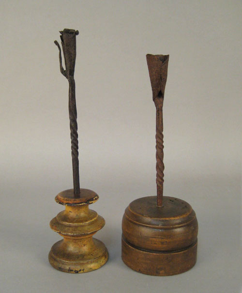 Appraisal: Two wrought iron candlesticks th c with turned wood bases