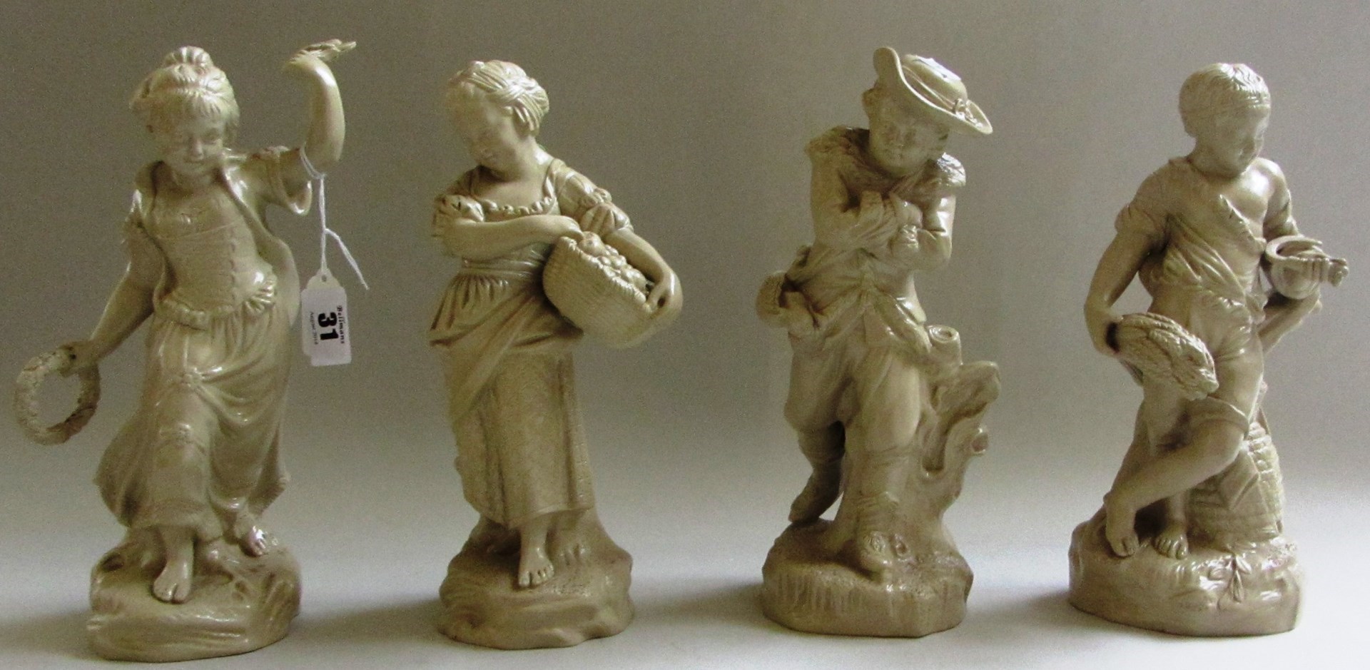 Appraisal: A group of four Staffordshire buff stoneware figures representing the