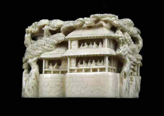 Appraisal: An Edo period ivory solid landscape netsuke carved with crowded