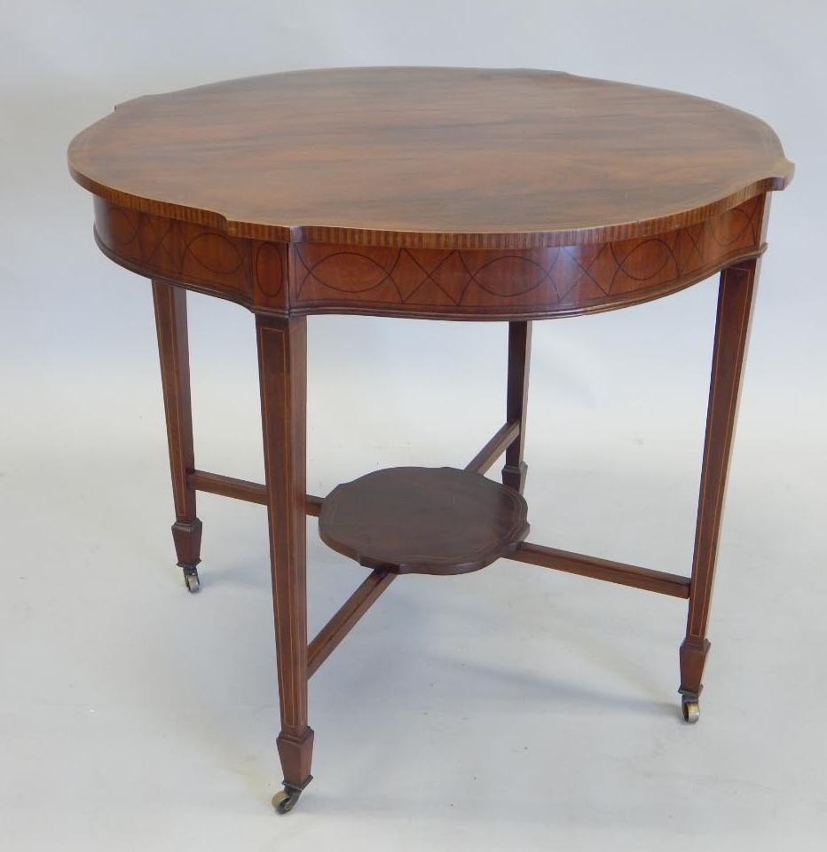 Appraisal: An Edwardian mahogany window table the shaped top with a