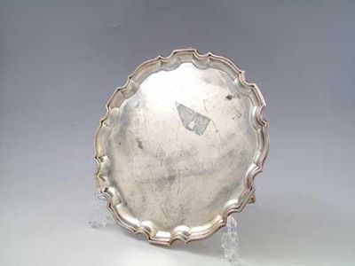 Appraisal: A modern salver of shaped outline on three feet by