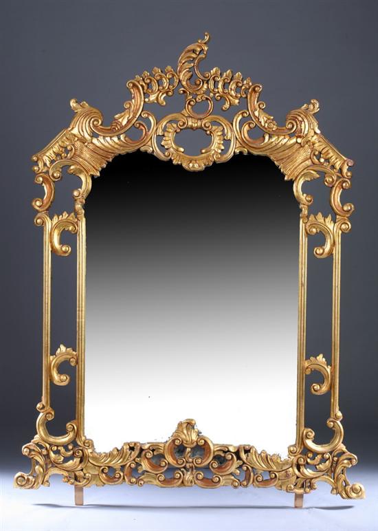 Appraisal: ROCOCO STYLE GILTWOOD WALL MIRROR late th century Open-work scrolling