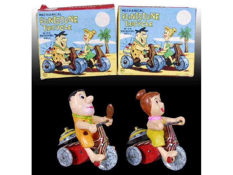 Appraisal: Lot of Marx Wind-Up Flintstone Tricycle Toys wi Description Both