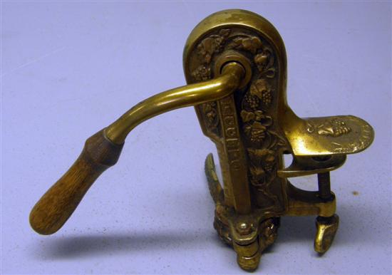 Appraisal: Table top brass cork screw bottle opener with embossed decoration