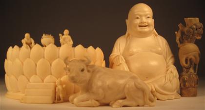 Appraisal: Four Asian ivory itemsComprising a lotus box base a Budai