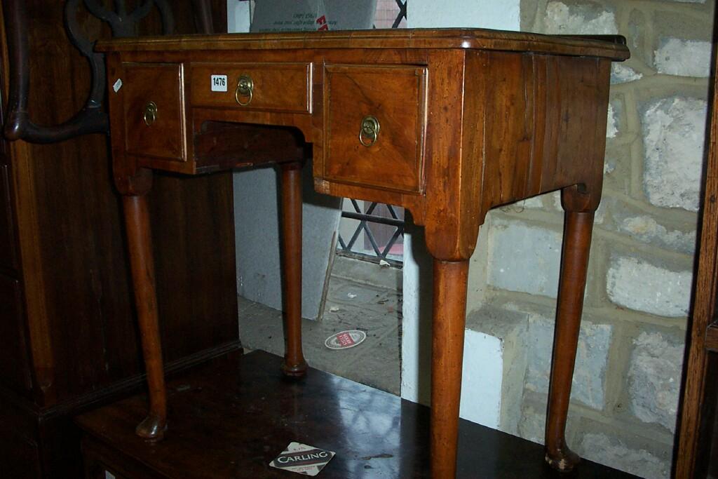 Appraisal: An th century walnut lowboy fitted with frieze drawers beneath