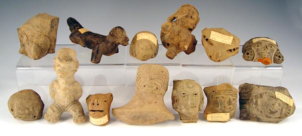 Appraisal: PRECOLUMBIAN ECUADORIAN CARVINGS Assorted artifacts including dog faces idols Several