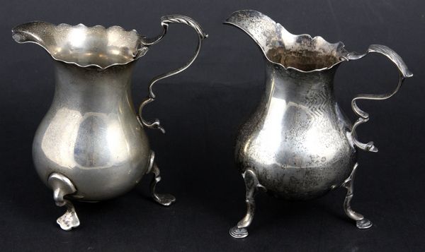 Appraisal: Two English silver cream pitchers with scalloped rims double 'c'