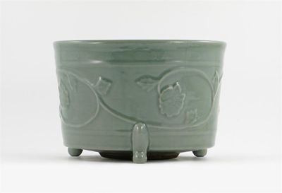 Appraisal: A Chinese Longquan celadon large tripod censer relief moulded with