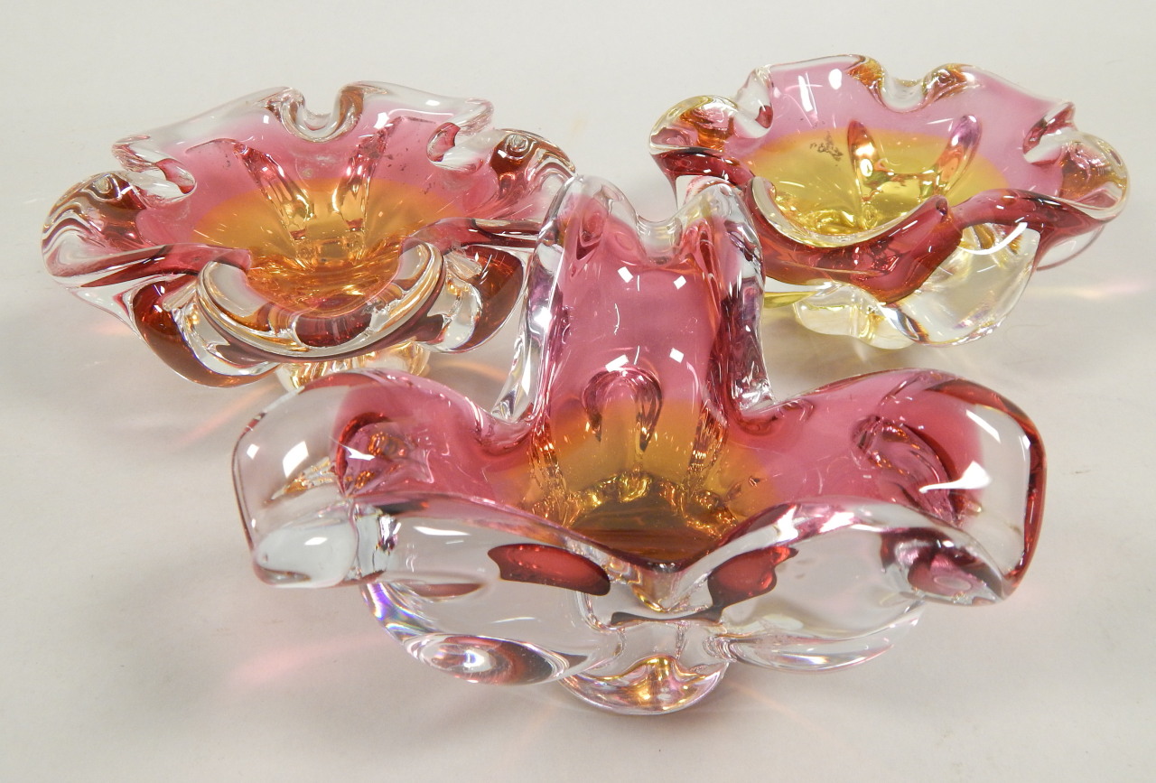 Appraisal: Three similar pink and yellow tinted Czech type ash trays