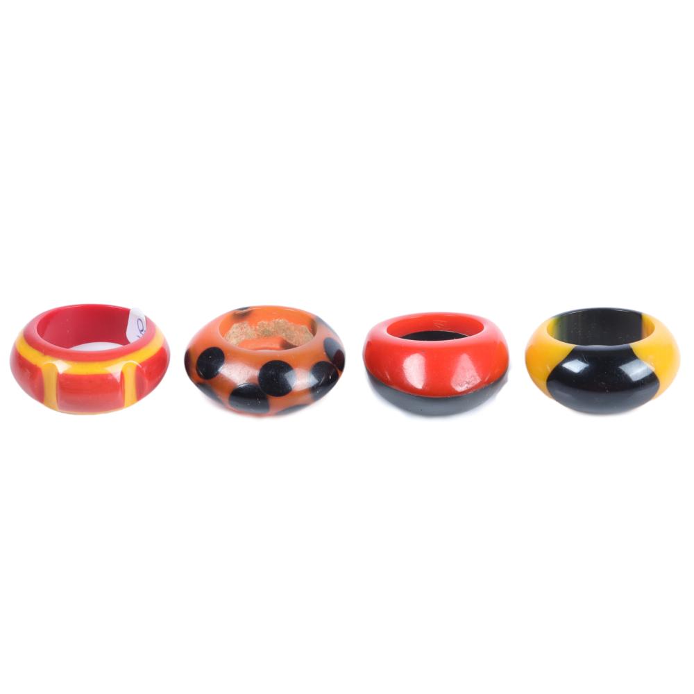 Appraisal: FOUR GEOMETRIC MULTICOLOR LAMINATED BAKELITE RINGS H X DIA RING