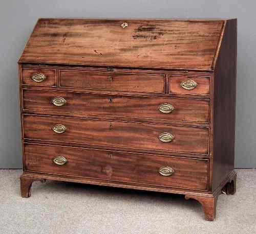 Appraisal: A George III figured mahogany bureau the slope enclosing fitted