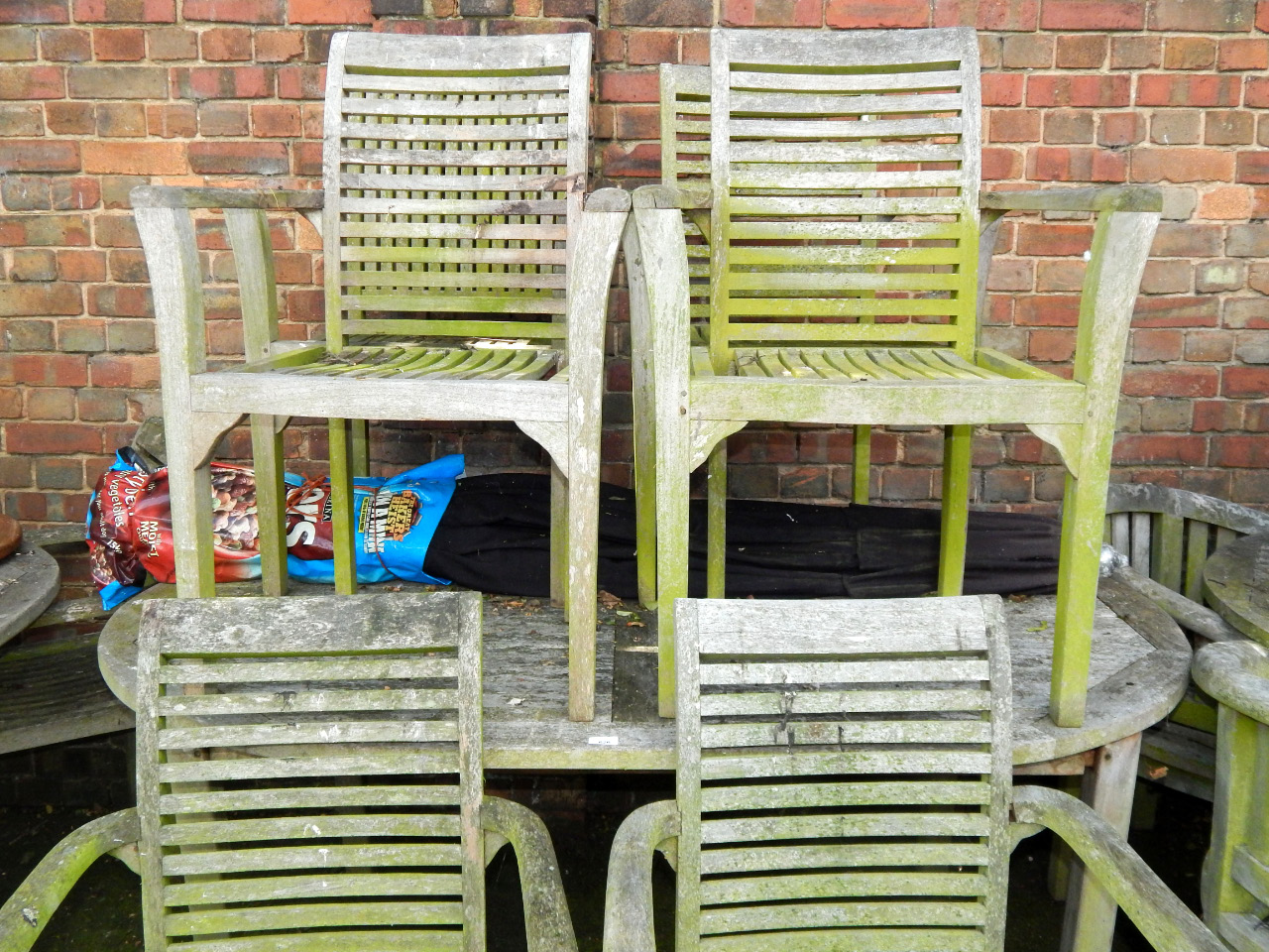 Appraisal: An oval garden table and six carver chairs