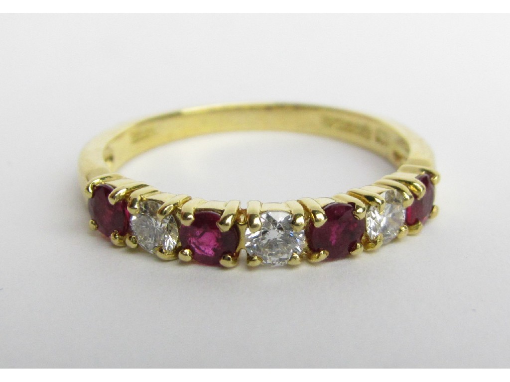 Appraisal: Nine carat gold ruby and diamond seven stone half hoop