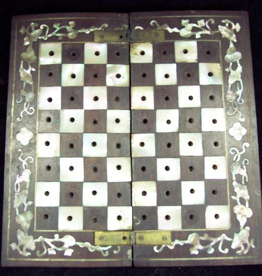 Appraisal: An Eastern miniature chess set in red and white ivory