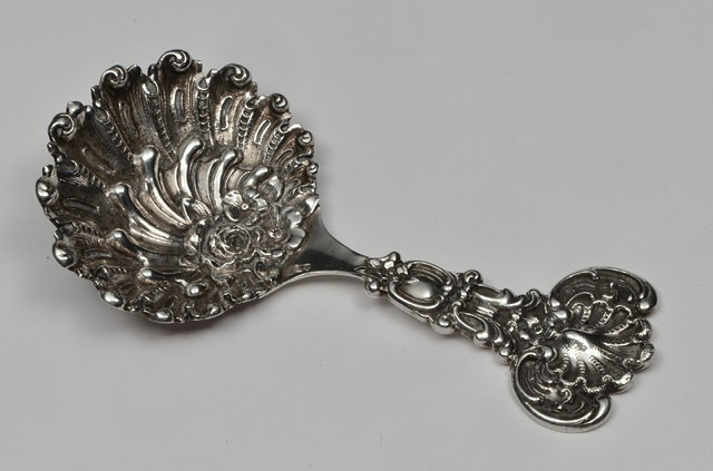 Appraisal: A SILVER CADDY SPOON with a shell scroll and foliate