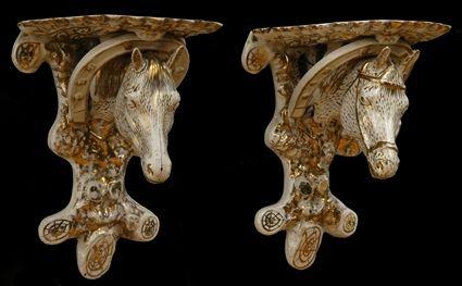 Appraisal: PAIR OF ENGLISH GILT-DECORATED IVORY-GLAZED POTTERY HORSE-HEAD WALL BRACKETS Each