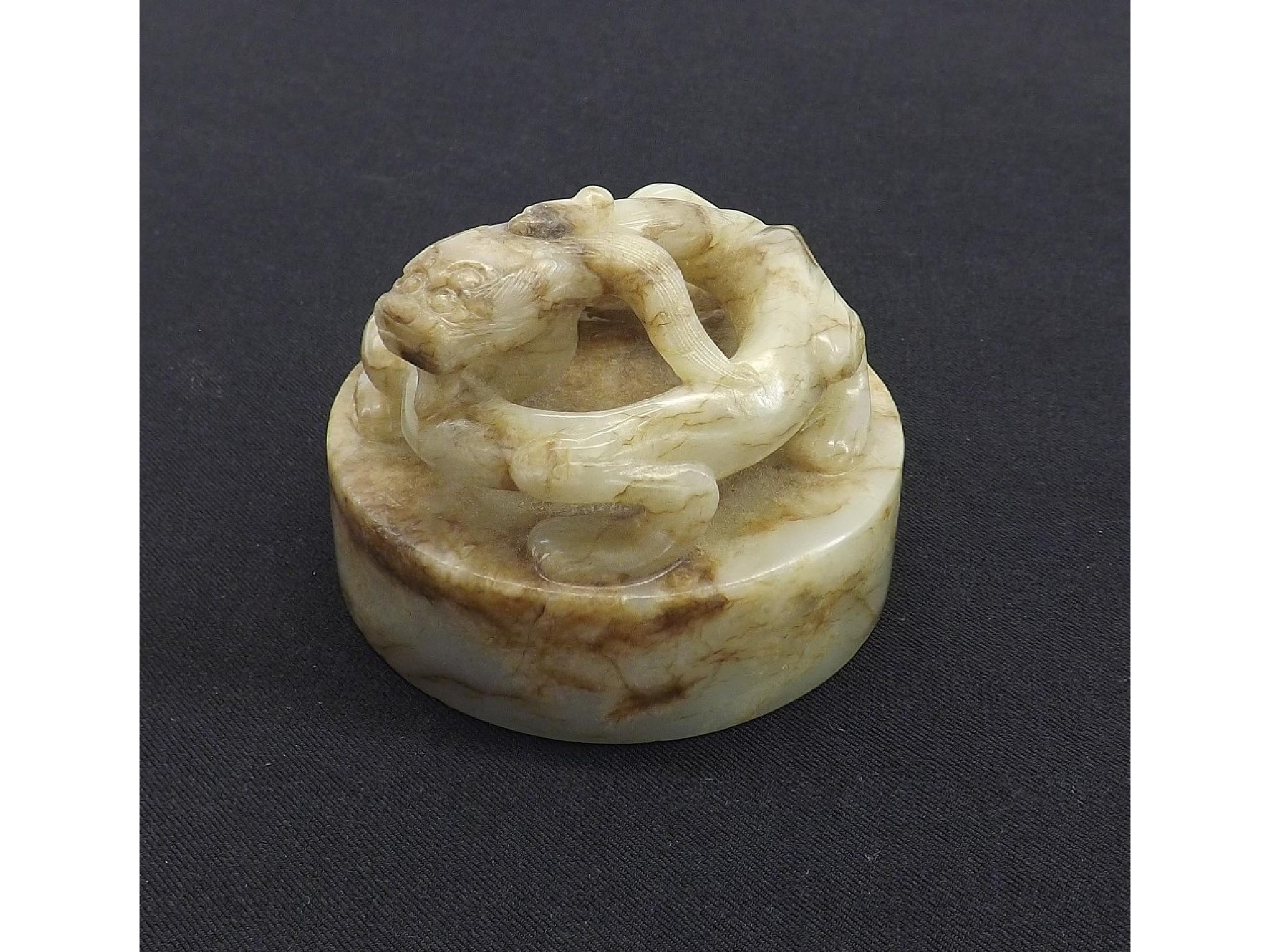 Appraisal: Celadon and mottled brown circular jade seal surmounted by mythical