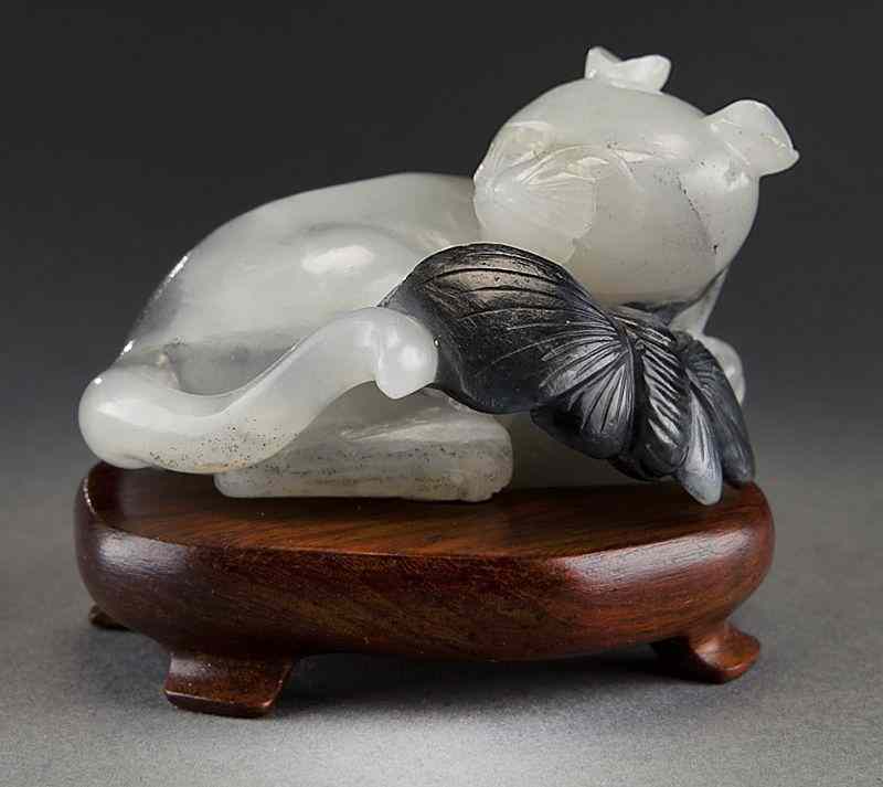 Appraisal: Chinese Qing carved black and white jadecat with a butterfly