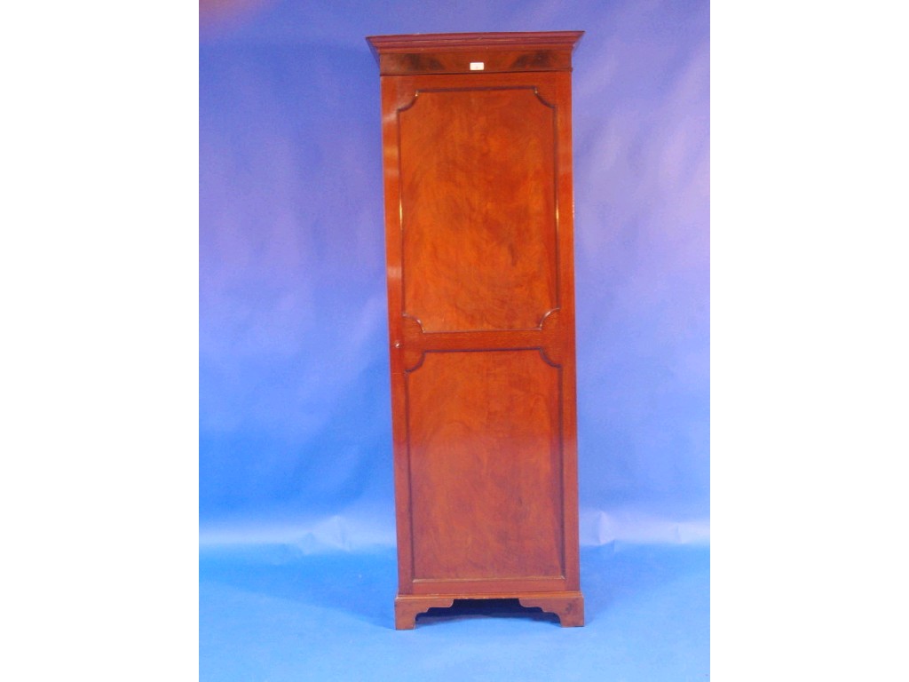 Appraisal: An Edwardian flamed mahogany wardrobe with moulded cornice single door