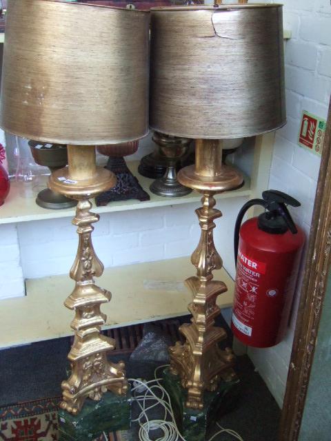 Appraisal: A pair of giltwood altar-type lamps converted from candle stands