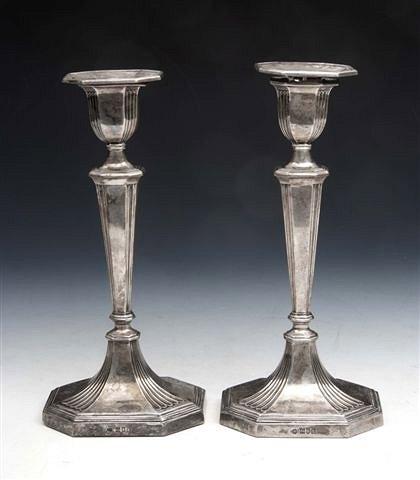 Appraisal: A PAIR OF EDWARDIAN SILVER CANDLESTICKS on fluted hexagonal base