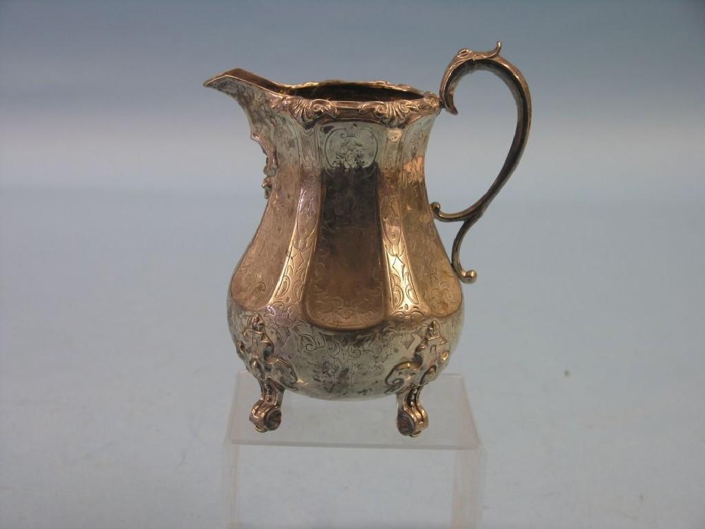 Appraisal: A Victorian silver milk jug bulbous-shape engraved with leaf-scrolls throughout